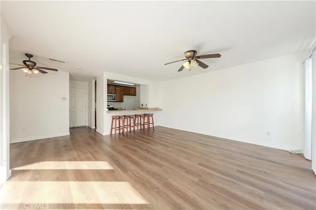 a view of a livingroom with a hardwood floor and a ceiling fan