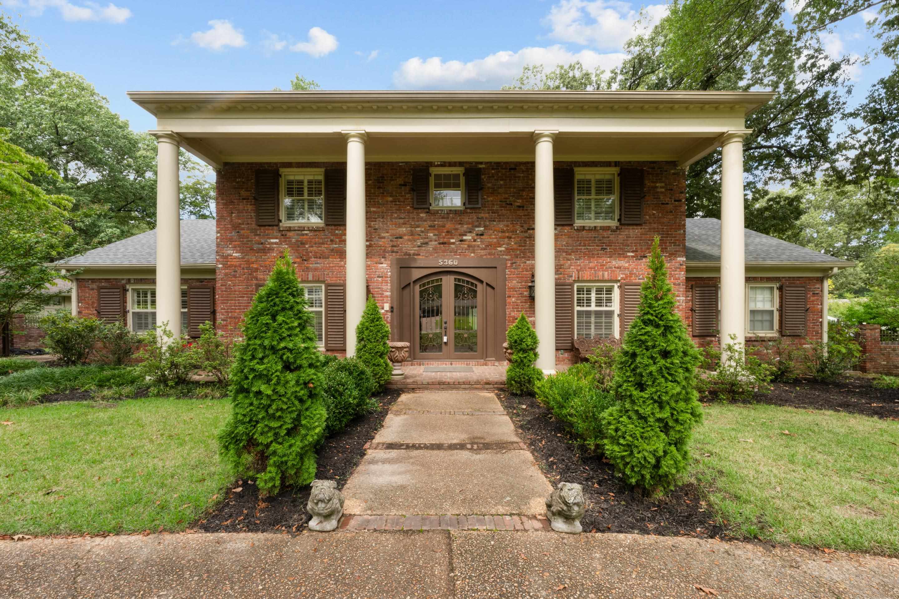 Neoclassical home featuring custom iron french doors