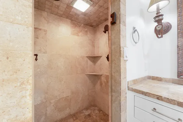 a bathroom with a granite countertop shower curtain and a sink