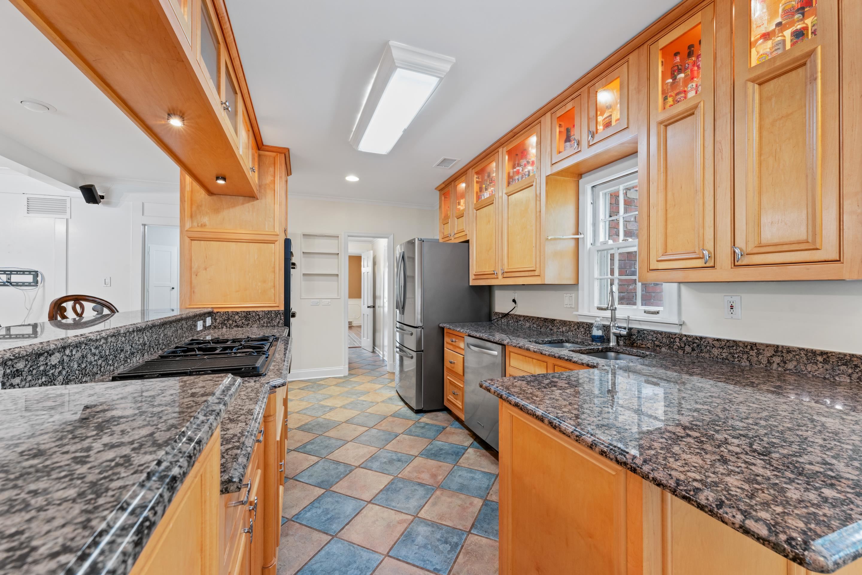 5360 Normandy Road Memphis, TN 38120 - Photo 19 of 40 a large kitchen with stainless steel appliances kitchen island granite countertop a sink and cabinets