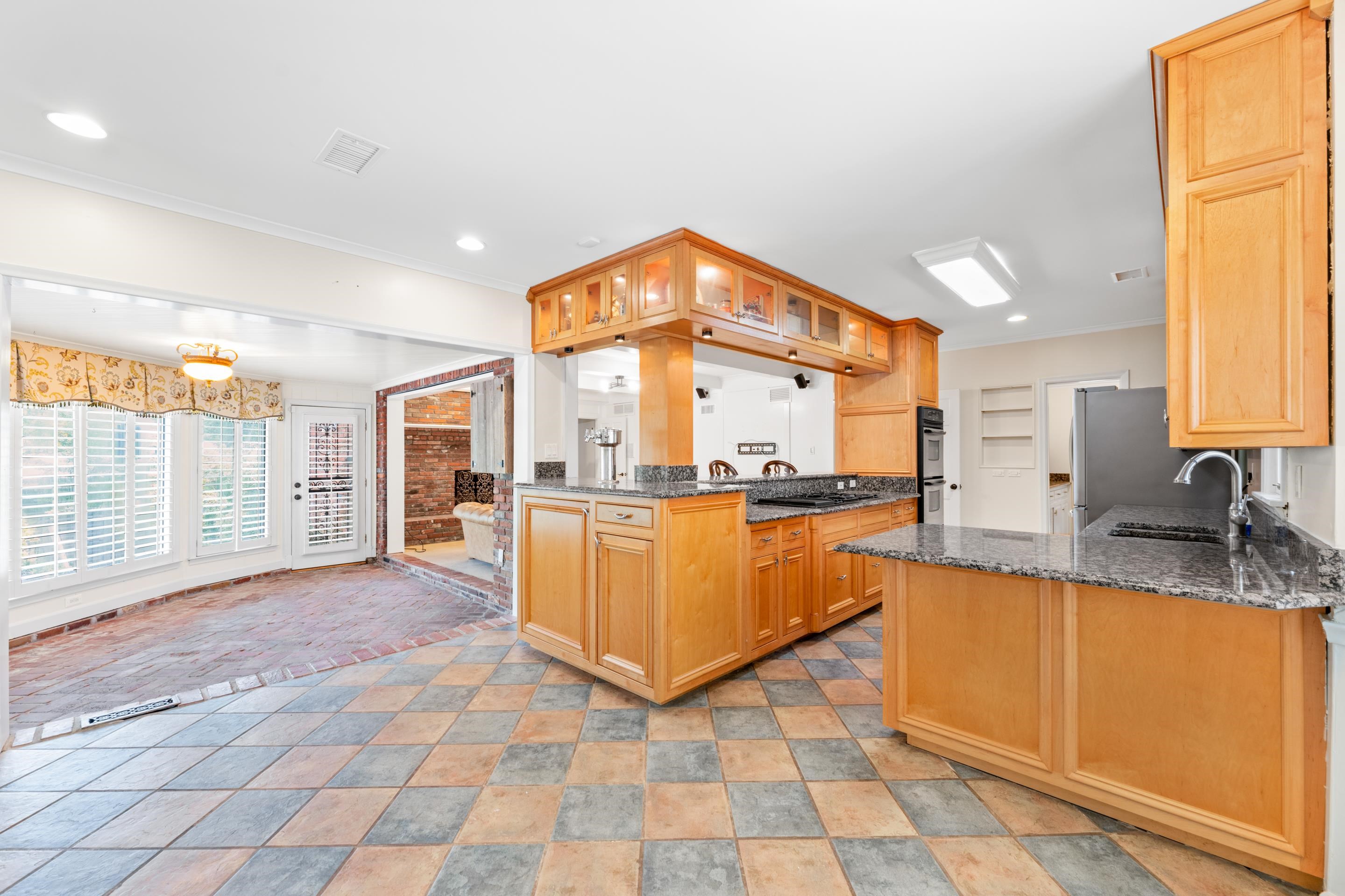 5360 Normandy Road Memphis, TN 38120 - Photo 22 of 40 a view of a kitchen with kitchen island granite countertop a large window and a sink