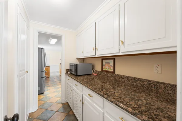 wooden floor with white cabinets