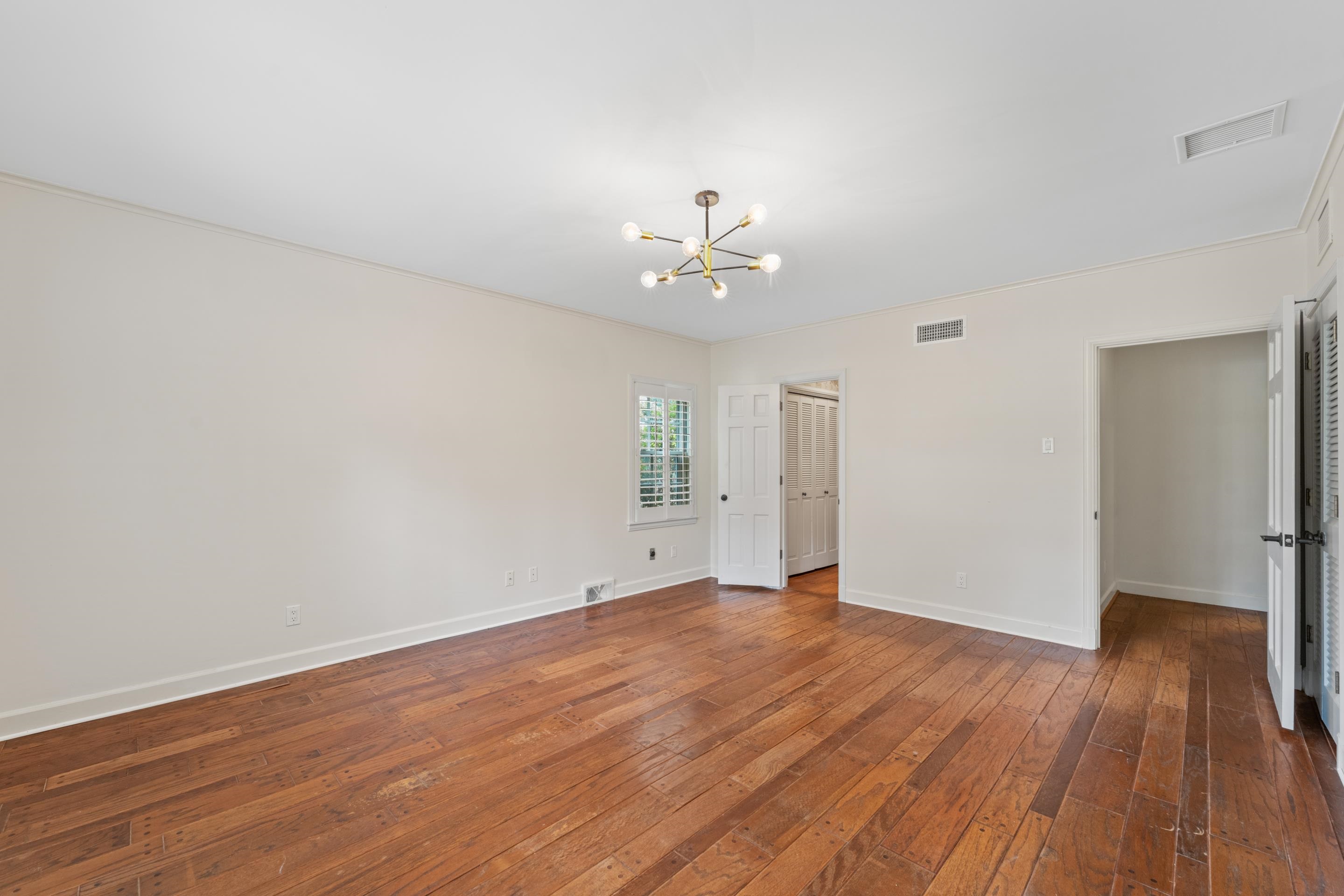 5360 Normandy Road Memphis, TN 38120 - Photo 30 of 40 wooden floor in an empty room with a window