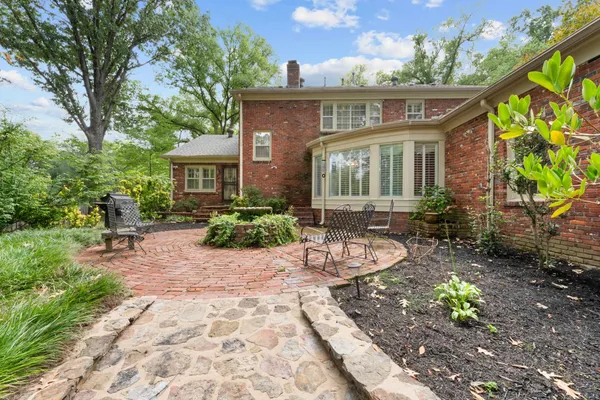 a view of a house with backyard sitting area and garden
