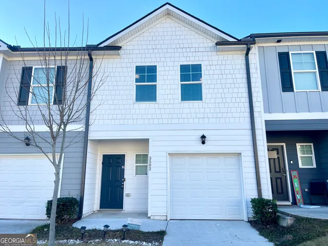 a front view of a house with garage