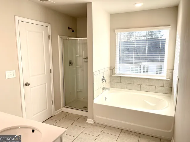 a bathroom with a bathtub and a shower