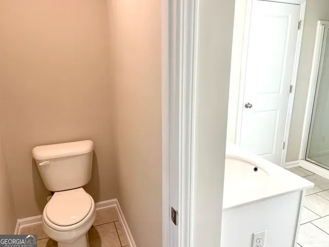 a white toilet sitting next to a bathroom sink