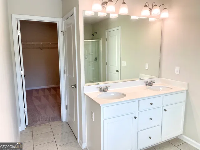 a bathroom with a sink a light fixture a vanity and a mirror