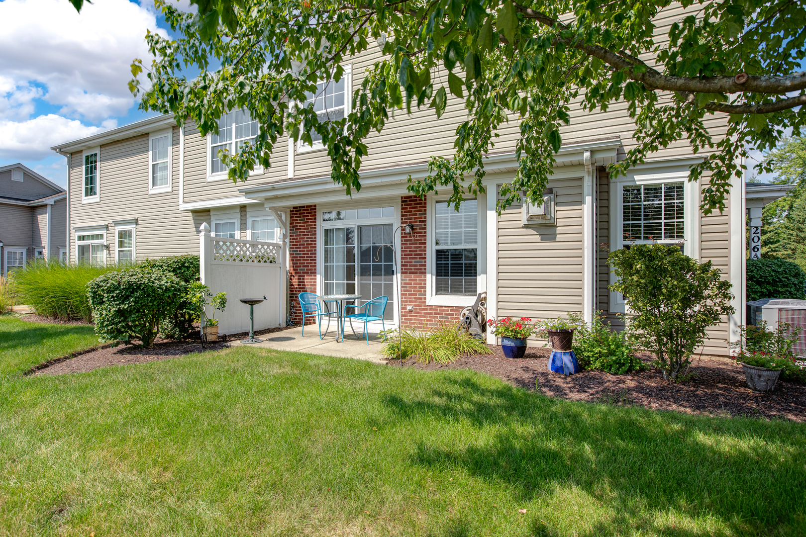 206 Brompton Lane, Unit A Sugar Grove, IL 60554 - Photo 3 of 17 front view of a house with a yard and an trees
