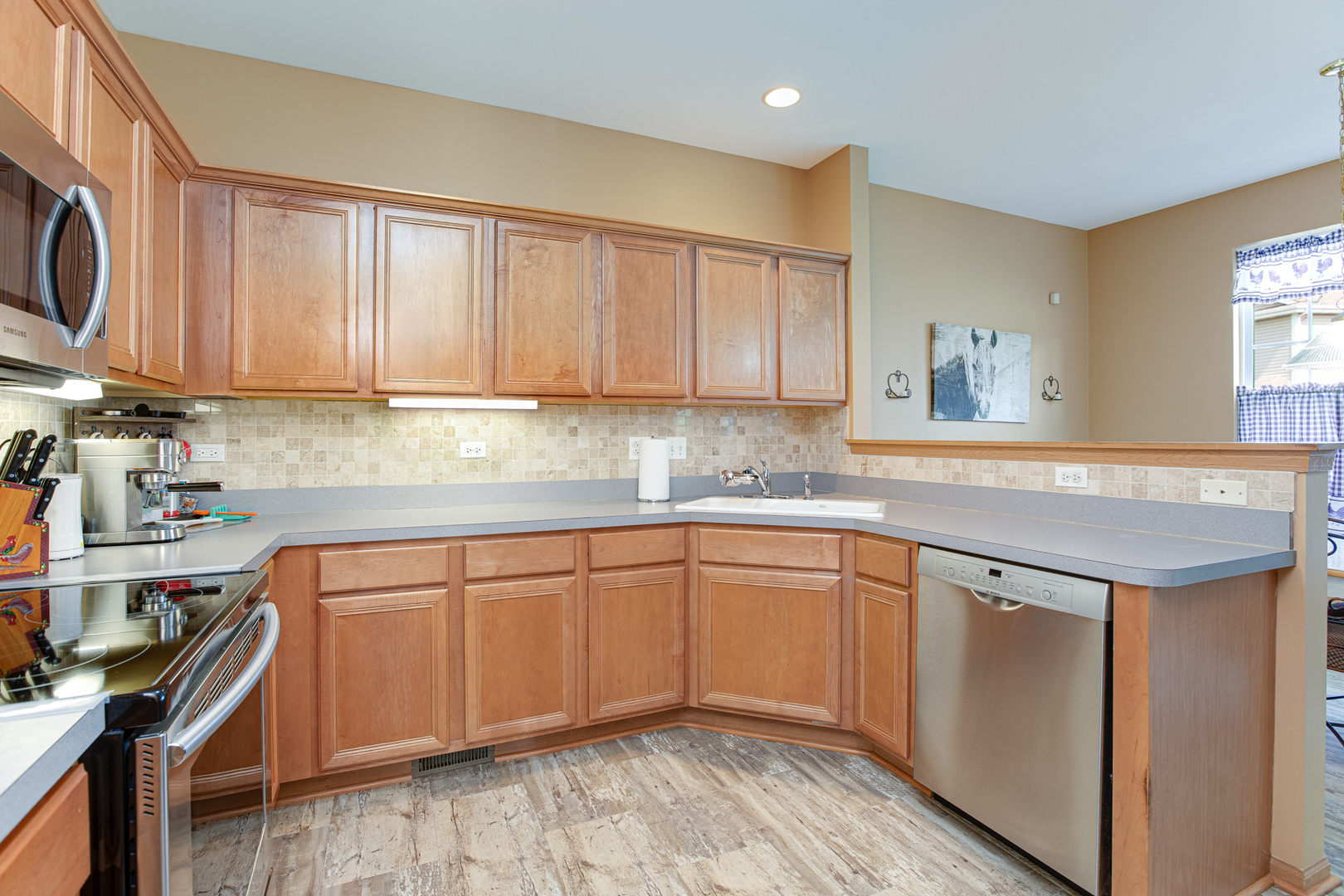 206 Brompton Lane, Unit A Sugar Grove, IL 60554 - Photo 9 of 17 a kitchen with stainless steel appliances granite countertop a sink stove and cabinets