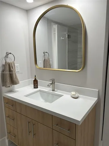 a bathroom with a sink and a mirror