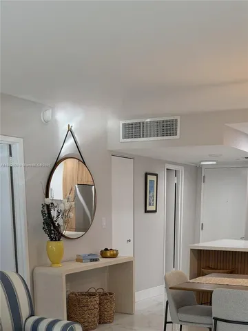 a living room with furniture and a mirror