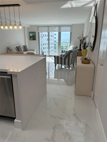 a view of a kitchen with furniture and a window