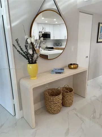 a room with a mirror and chandelier