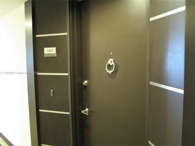 a living room with couches and a potted plant on a table