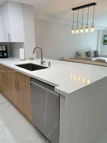 a kitchen with a sink and cabinets