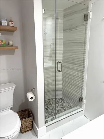 a bathroom with a toilet and shower