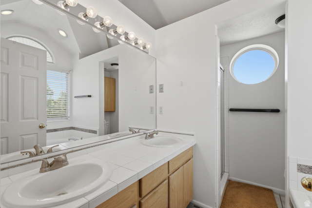 5788 Walden Ridge Drive Murray, UT 84123 - Photo 17 of 29 Dual vanity with wood-finish cabinetry and a tiled countertop