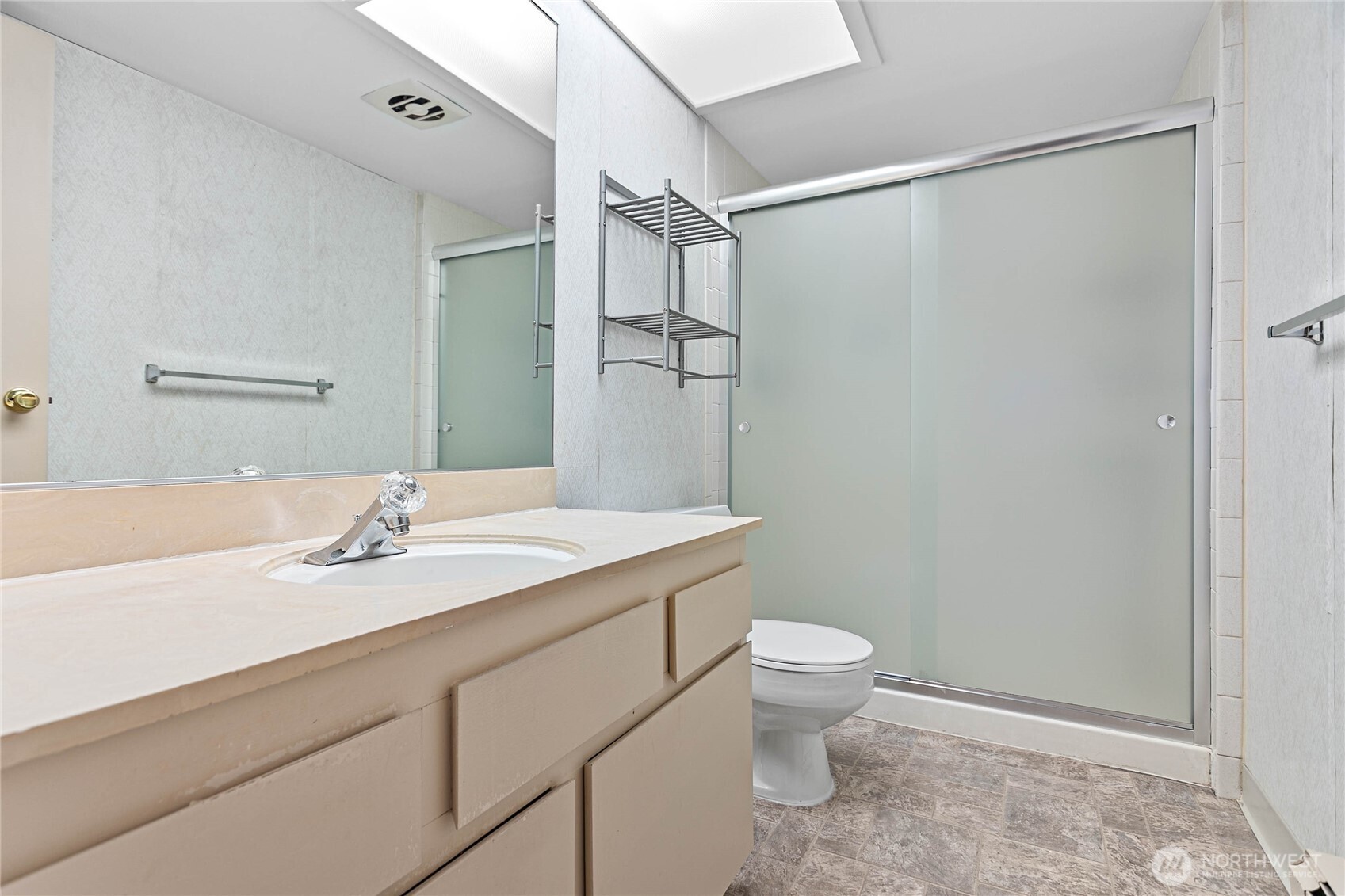 600 South State Street, Unit 208 Bellingham, WA 98225 - Photo 22 of 34 a bathroom with a granite countertop sink toilet and shower