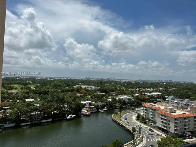 an aerial view of residential building with lake view and boat