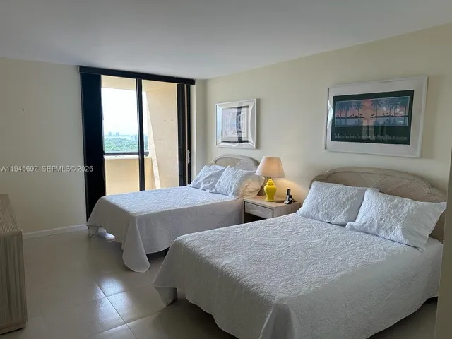 a bedroom with two beds and a window