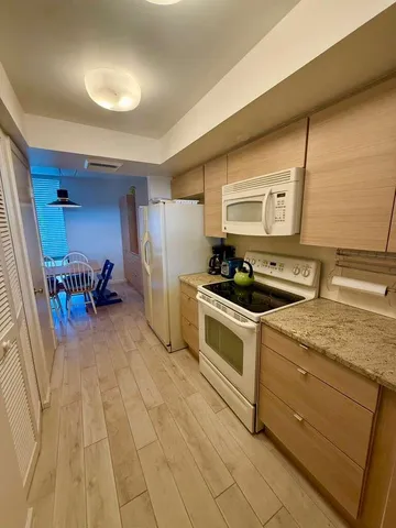 a living room with furniture a rug and a table