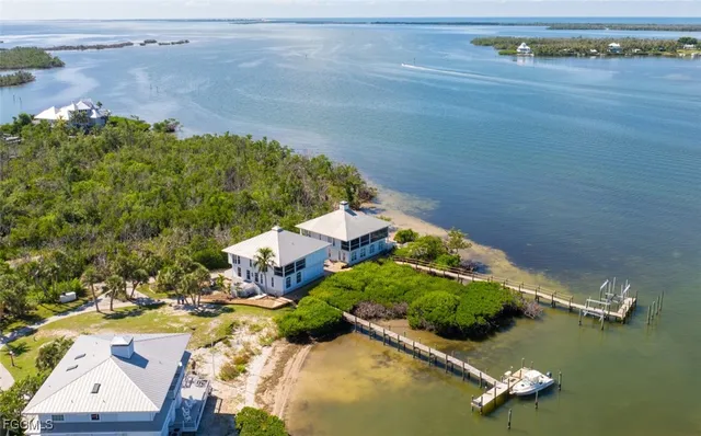an aerial view of a house with a ocean view