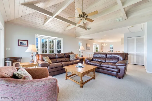 a view of a hallway with dining room and furniture