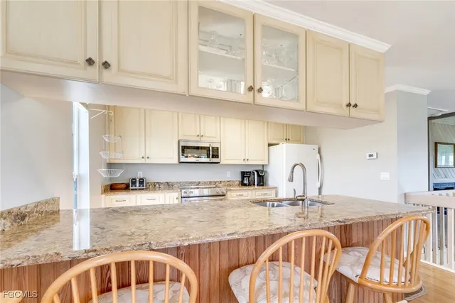 a kitchen with granite countertop a sink and cabinets