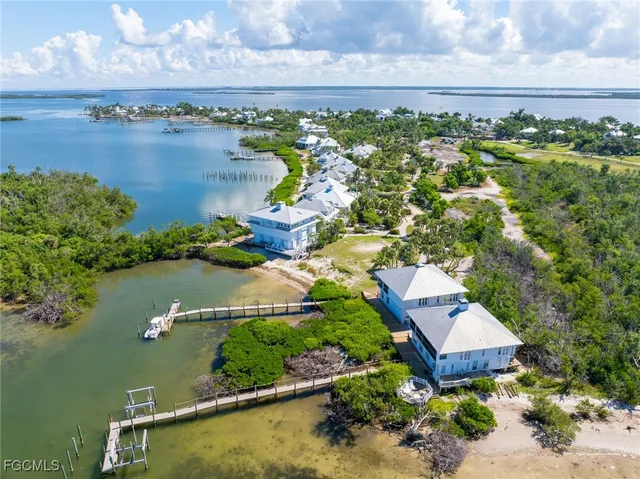 an aerial view of lake and residential houses with outdoor space