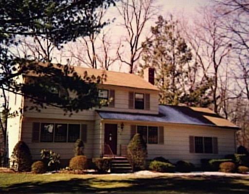 15 Chapel Hill Road Westport, CT 06880 - Photo 1 of 1 a front view of house with yard and trees around