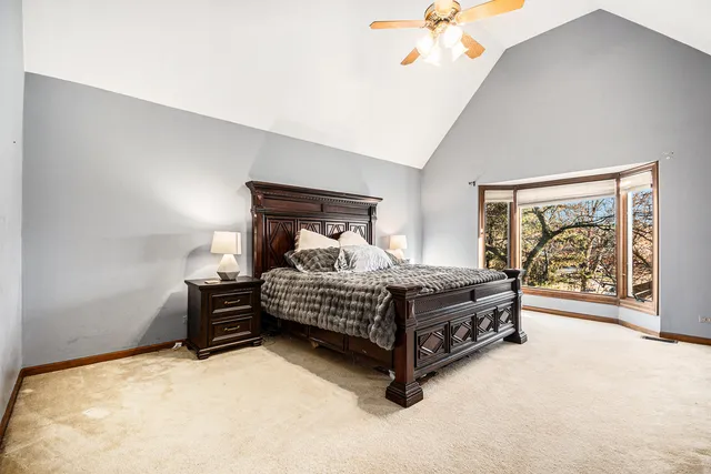 a bedroom with a bed and a painting on the wall