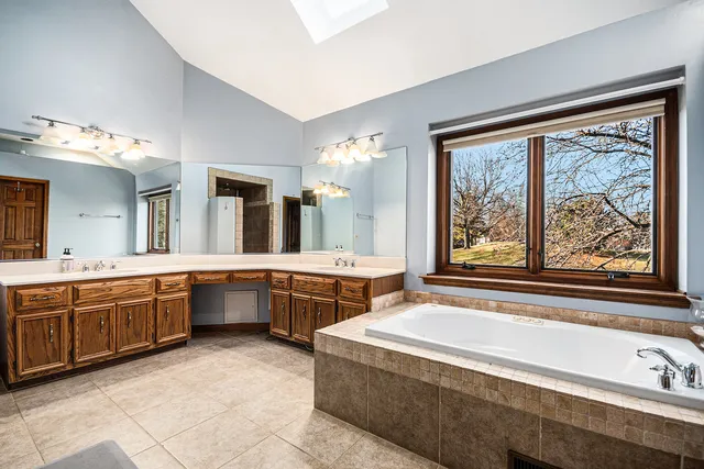 a large spacious bathroom with a large tub and sink