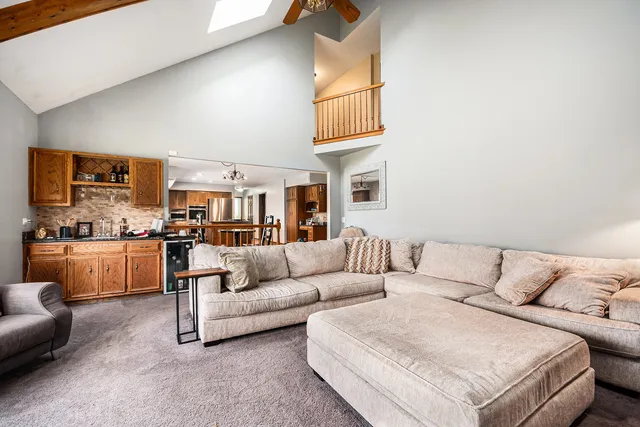 a living room with furniture and kitchen view