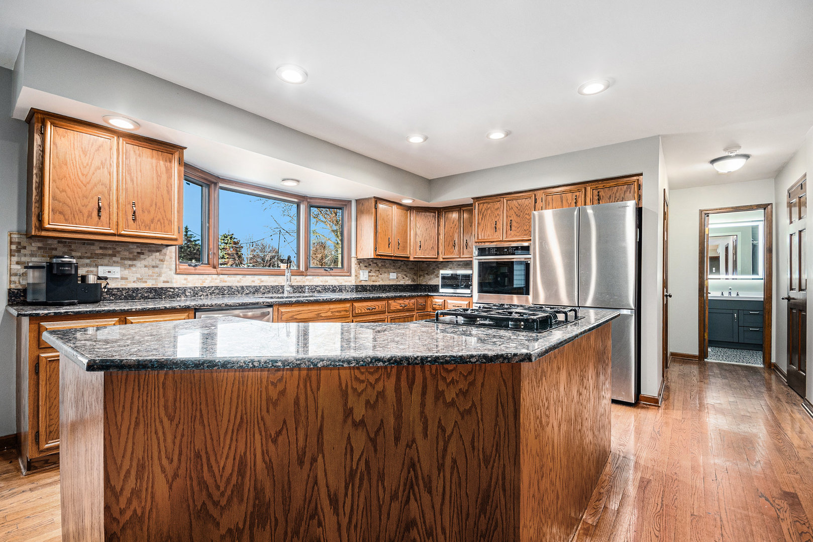 3942 Broadmoor Circle Naperville, IL 60564 - Photo 9 of 25 a kitchen with stainless steel appliances granite countertop a stove a sink a refrigerator and a oven