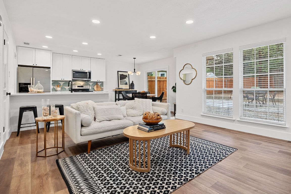 a living room with furniture a rug and a table