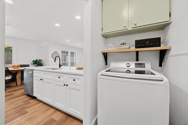 a kitchen with sink a stove and cabinets