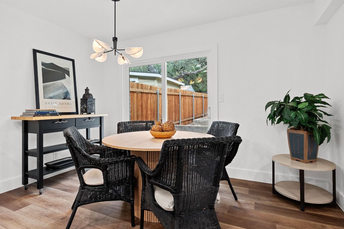 1504 Allen Road, Unit C Austin, TX 78746 - Photo 12 of 26 a view of a dining room with furniture window and wooden floor