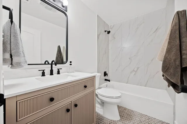 a bathroom with a sink a toilet and a bathtub