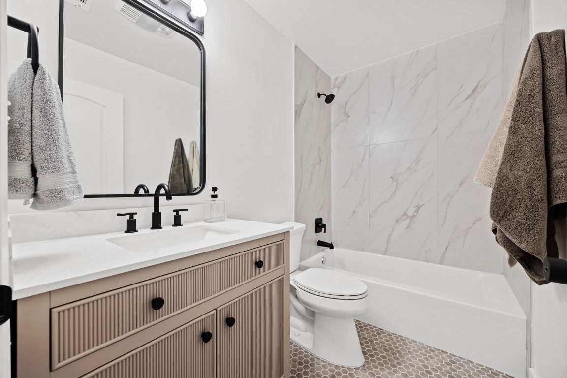 1504 Allen Road, Unit C Austin, TX 78746 - Photo 16 of 26 a bathroom with a sink a toilet and a bathtub