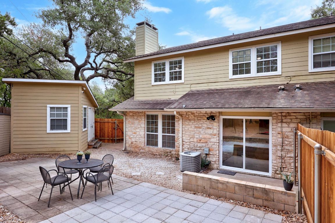 1504 Allen Road, Unit C Austin, TX 78746 - Photo 18 of 26 a front view of a house with a chairs and table in a patio