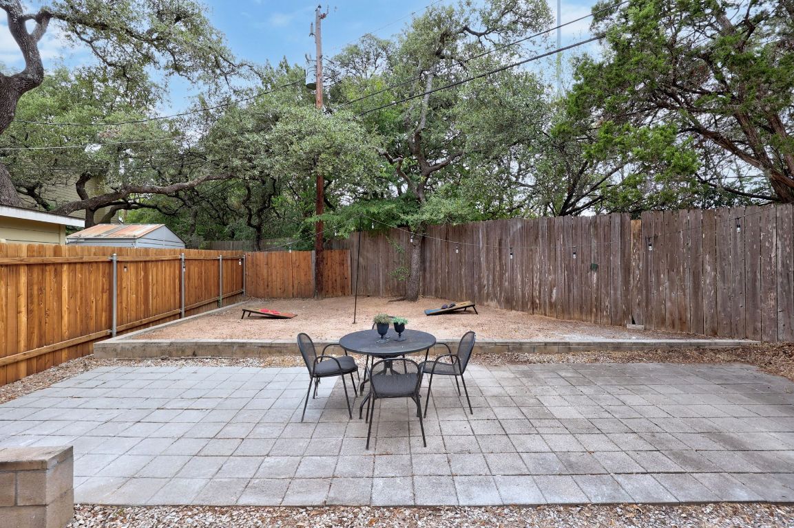 1504 Allen Road, Unit C Austin, TX 78746 - Photo 24 of 26 a backyard of a house with table and chairs