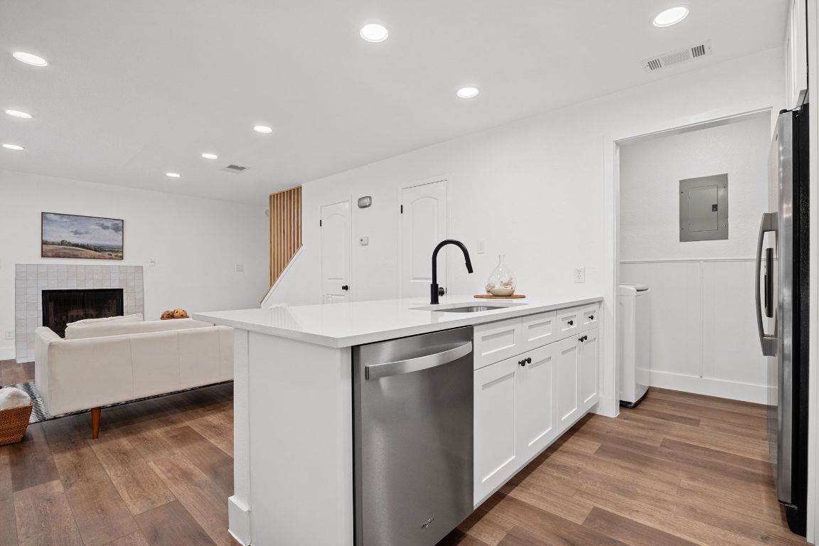 1504 Allen Road, Unit C Austin, TX 78746 - Photo 9 of 26 a view of a kitchen with sink dishwasher and wooden floor