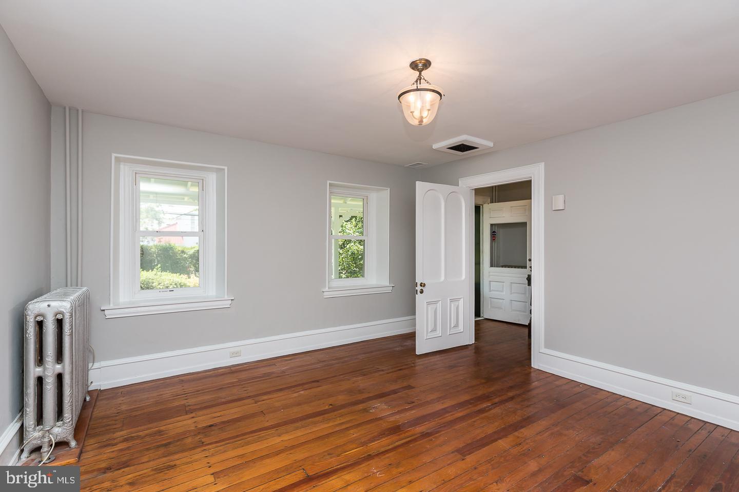 337 Righters Mill Road Gladwyne, PA 19035 - Photo 11 of 41 an empty room with wooden floor and windows