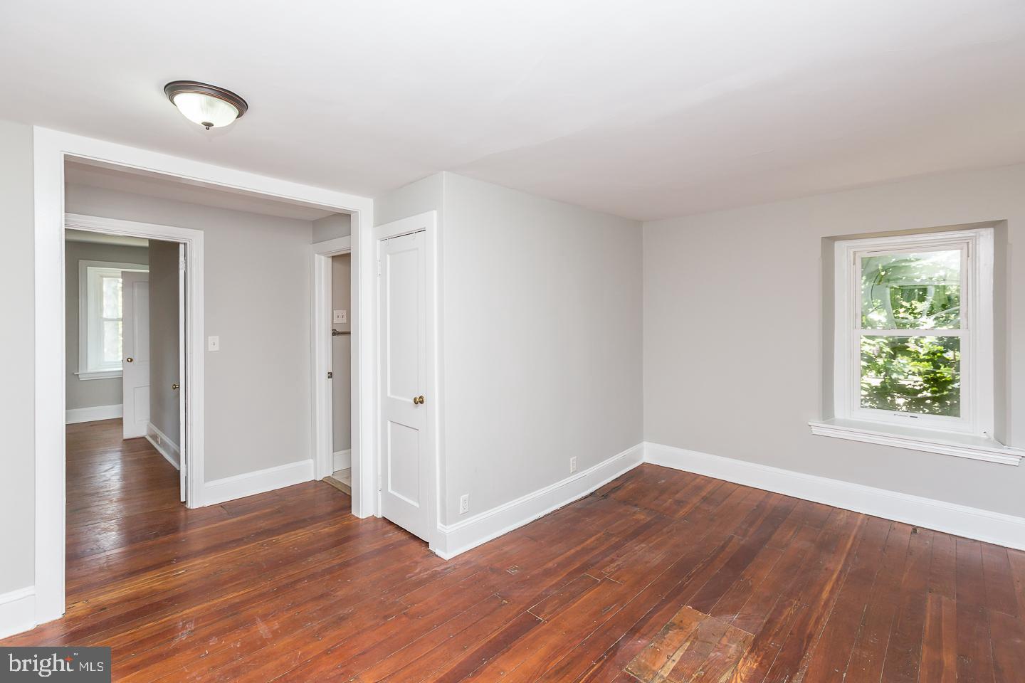 337 Righters Mill Road Gladwyne, PA 19035 - Photo 12 of 41 an empty room with wooden floor and windows