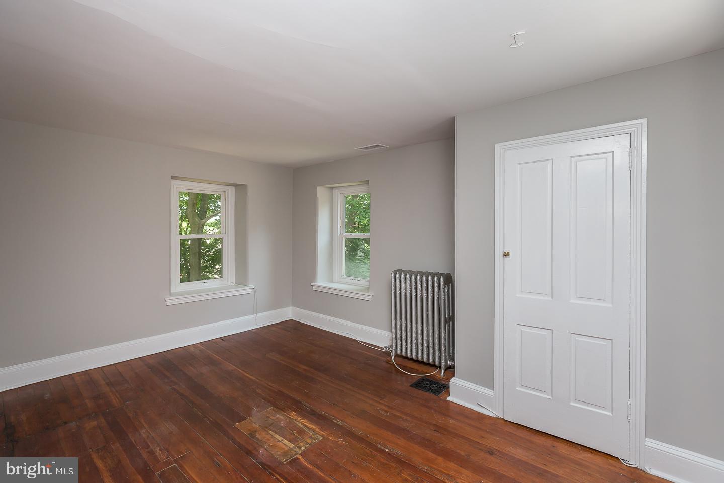 337 Righters Mill Road Gladwyne, PA 19035 - Photo 14 of 41 an empty room with wooden floor and windows