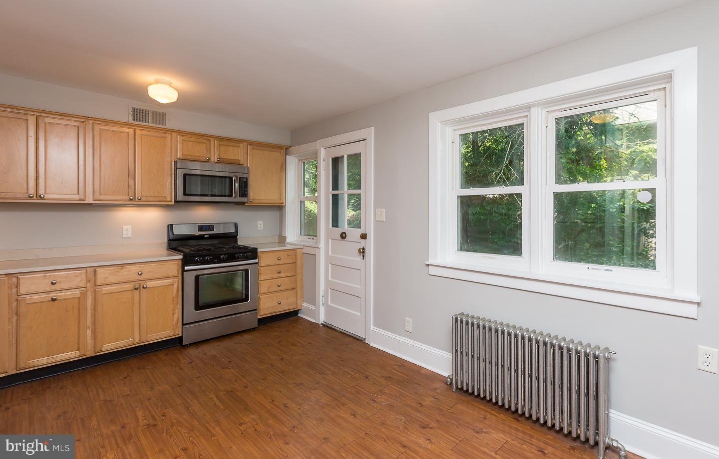 337 Righters Mill Road Gladwyne, PA 19035 - Photo 16 of 41 a kitchen with granite countertop a stove a sink and a microwave