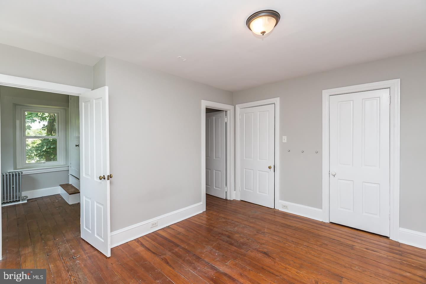 337 Righters Mill Road Gladwyne, PA 19035 - Photo 29 of 41 an empty room with wooden floor and windows