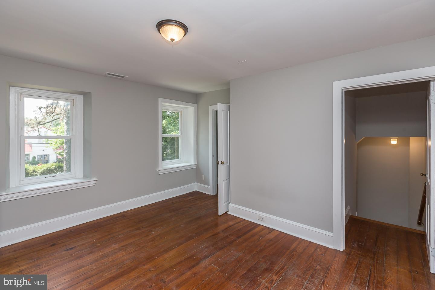 337 Righters Mill Road Gladwyne, PA 19035 - Photo 30 of 41 an empty room with wooden floor and windows