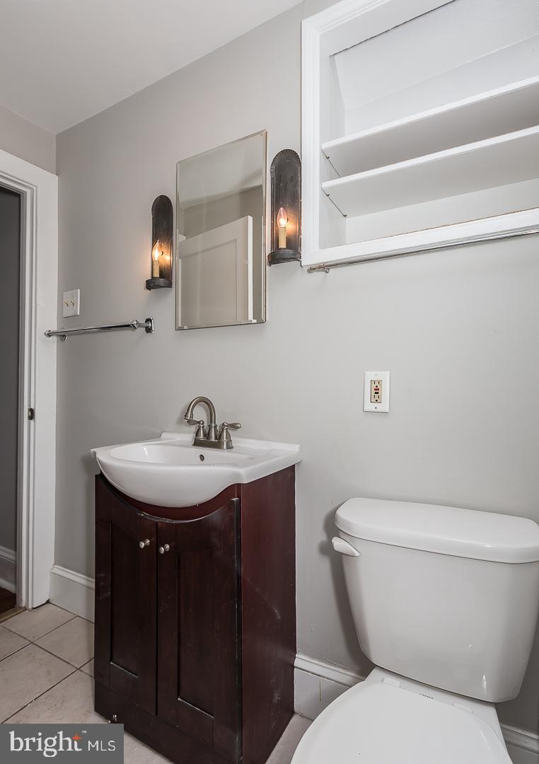 337 Righters Mill Road Gladwyne, PA 19035 - Photo 35 of 41 a bathroom with a toilet a sink and mirror
